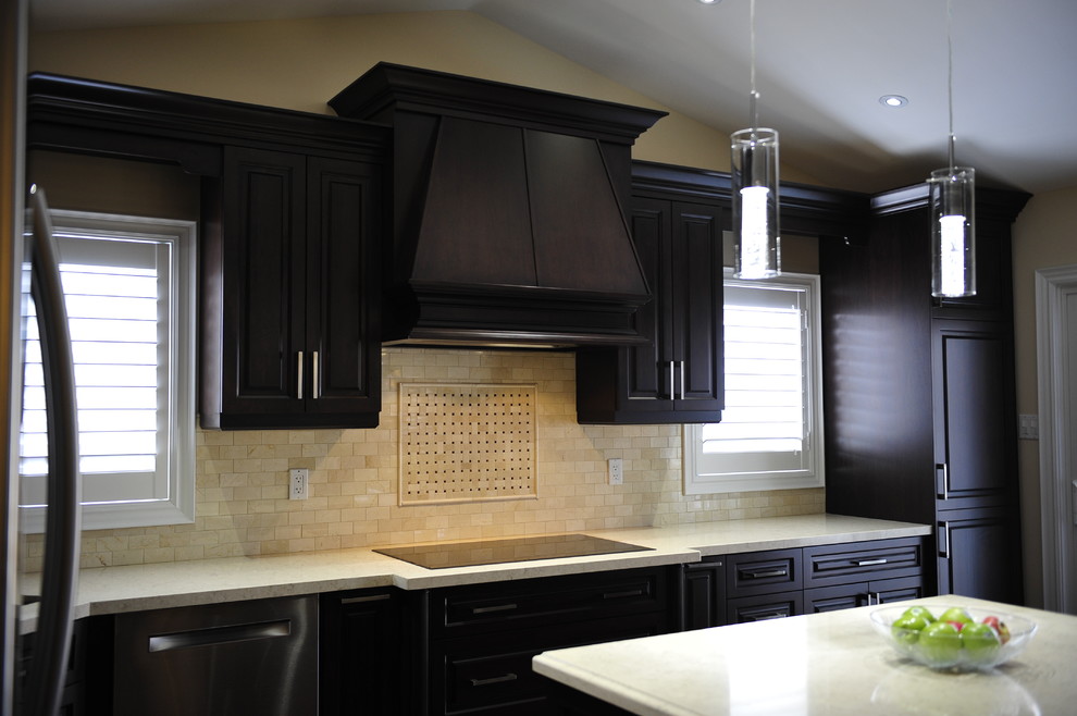 Mid-sized transitional u-shaped eat-in kitchen photo in Toronto with a double-bowl sink, raised-panel cabinets, dark wood cabinets, quartz countertops, multicolored backsplash, matchstick tile backsplash, stainless steel appliances and a peninsula