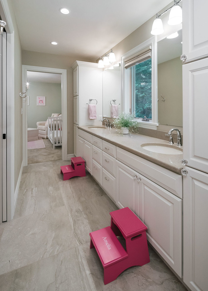 Mid-sized traditional kids bathroom in Other with raised-panel cabinets, white cabinets, beige tile, beige walls, porcelain floors, an undermount sink, engineered quartz benchtops, beige floor and beige benchtops.