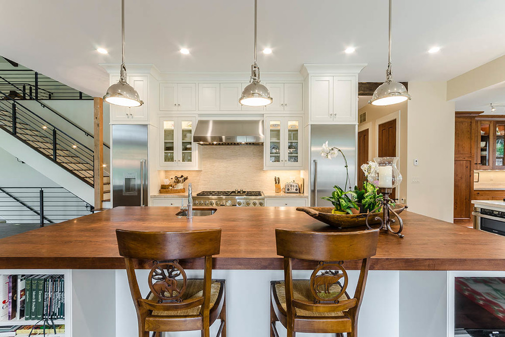 Eat-in kitchen - huge transitional l-shaped dark wood floor and brown floor eat-in kitchen idea with an undermount sink, shaker cabinets, white cabinets, wood countertops, gray backsplash, matchstick tile backsplash, stainless steel appliances and an island