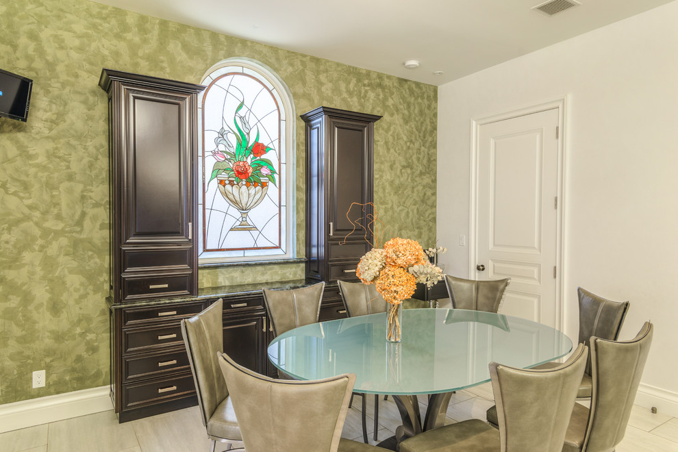This is an example of a mid-sized traditional separate dining room in Orange County with green walls, porcelain floors and white floor.