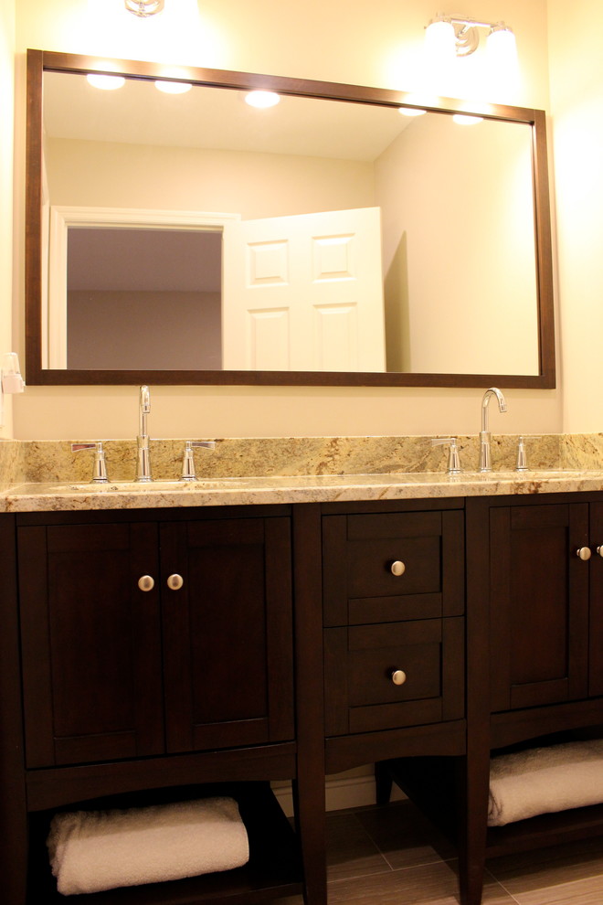 Alcove bathtub - small transitional kids' gray tile and porcelain tile porcelain tile alcove bathtub idea in Cincinnati with furniture-like cabinets, dark wood cabinets, a two-piece toilet, gray walls, an undermount sink and granite countertops