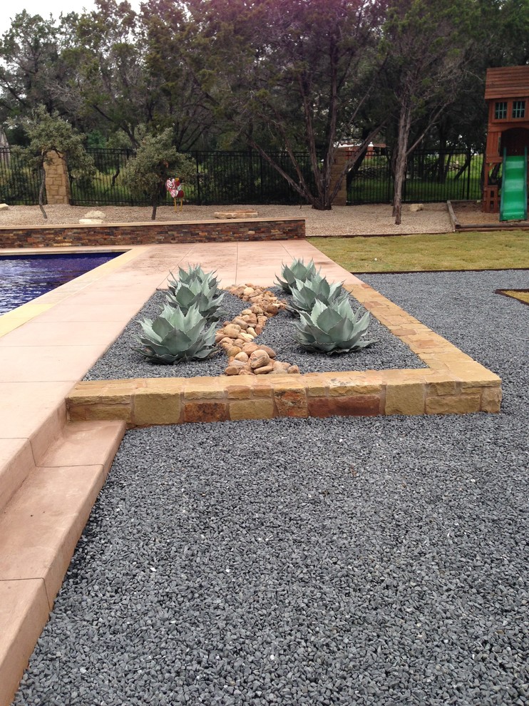 Design ideas for a mid-sized mediterranean backyard rectangular lap pool in Austin with a water feature and tile.