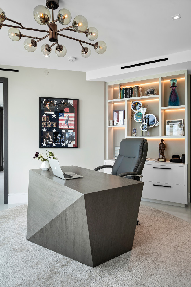Photo of a mid-sized contemporary study room in Miami with beige walls, marble floors, a freestanding desk and white floor.