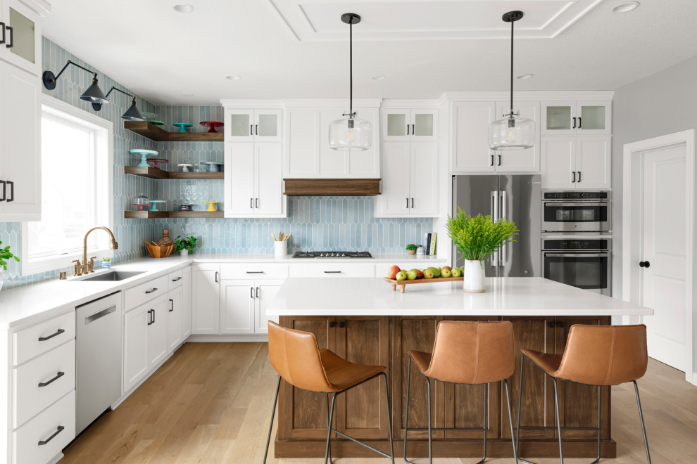 Kitchen - transitional kitchen idea in Minneapolis with white cabinets, quartz countertops, white countertops and an island