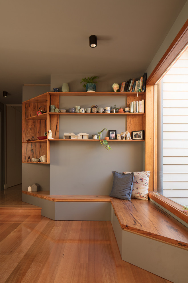 Photo of a mid-sized contemporary galley eat-in kitchen in Melbourne with a double-bowl sink, white cabinets, quartz benchtops, green splashback, ceramic splashback, stainless steel appliances, light hardwood floors, with island and white benchtop.