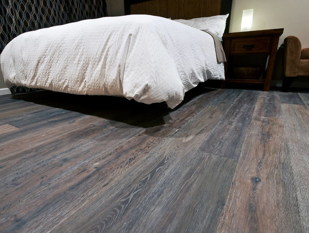 Transitional medium tone wood floor bedroom photo with beige walls and no fireplace