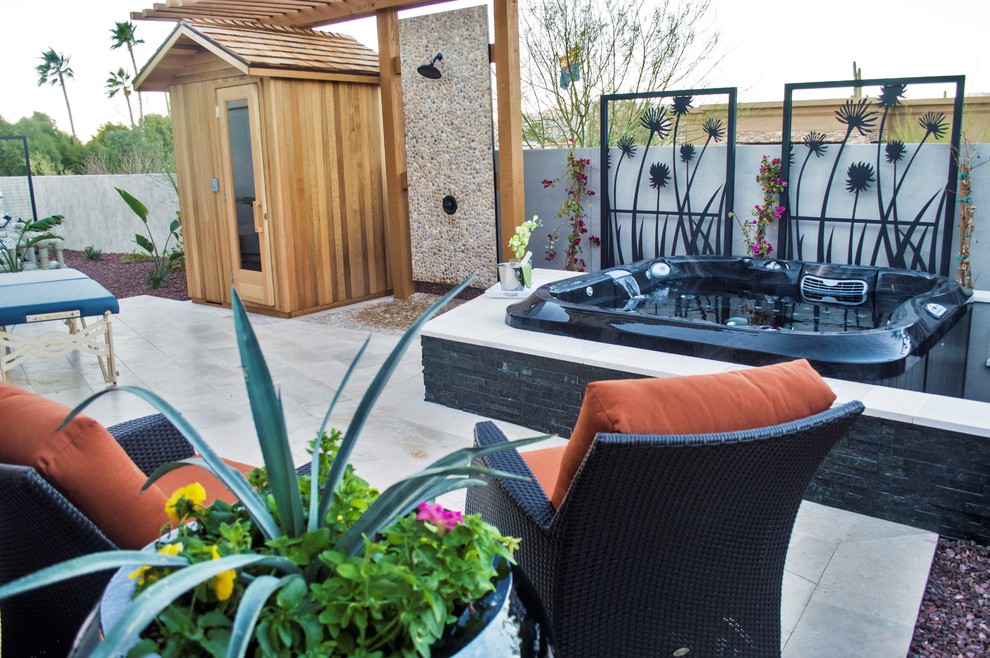 This is an example of a large modern backyard patio in Phoenix with an outdoor shower, stamped concrete and a pergola.