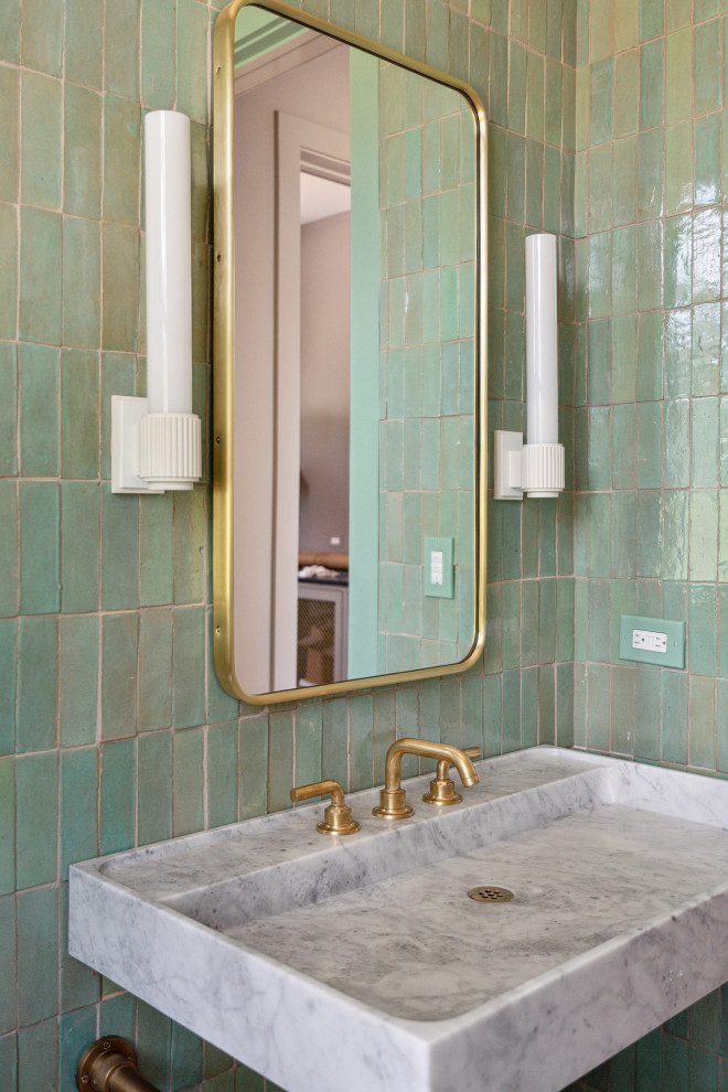 Inspiration for a modern powder room in Charleston with a one-piece toilet, green tile, terra-cotta tile, green walls, light hardwood floors, a console sink, marble benchtops and a freestanding vanity.