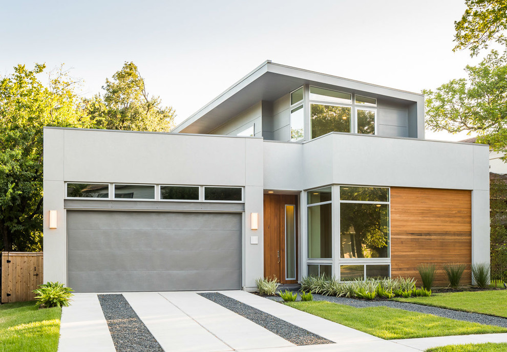 Design ideas for a contemporary two-storey grey exterior in Austin with a flat roof.