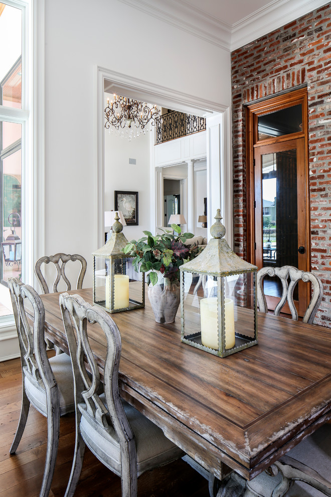 Photo of an expansive traditional kitchen/dining combo in New Orleans with white walls and medium hardwood floors.