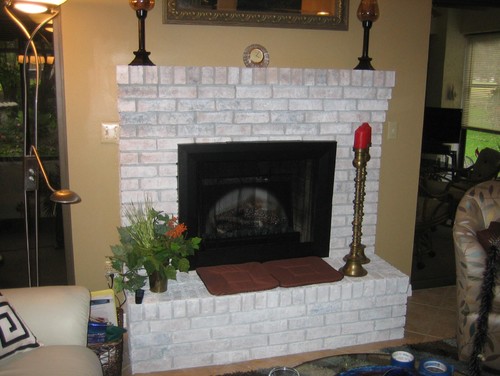 We recently gave our fireplace a light coat of white paint and would like to dress it up by putting large tiles on the raised hearth.  Sometimes we use the hearth for seating with or without pillows.  How do you finish off the front edge of the tiles when they are sitting on the bricks.  The hearth ...