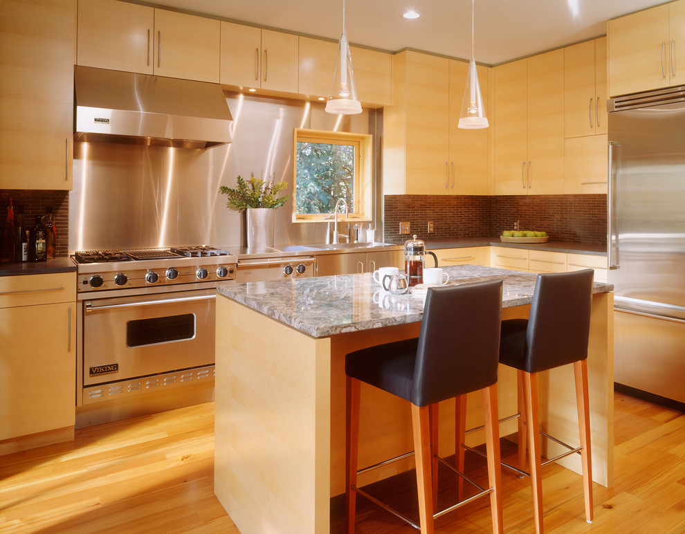 This is an example of a mid-sized contemporary l-shaped eat-in kitchen in Minneapolis with an undermount sink, flat-panel cabinets, light wood cabinets, marble benchtops, brown splashback, matchstick tile splashback, stainless steel appliances, medium hardwood floors, with island and brown floor.