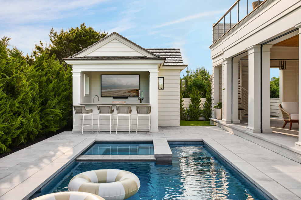 Beach style stone and rectangular pool photo in Philadelphia