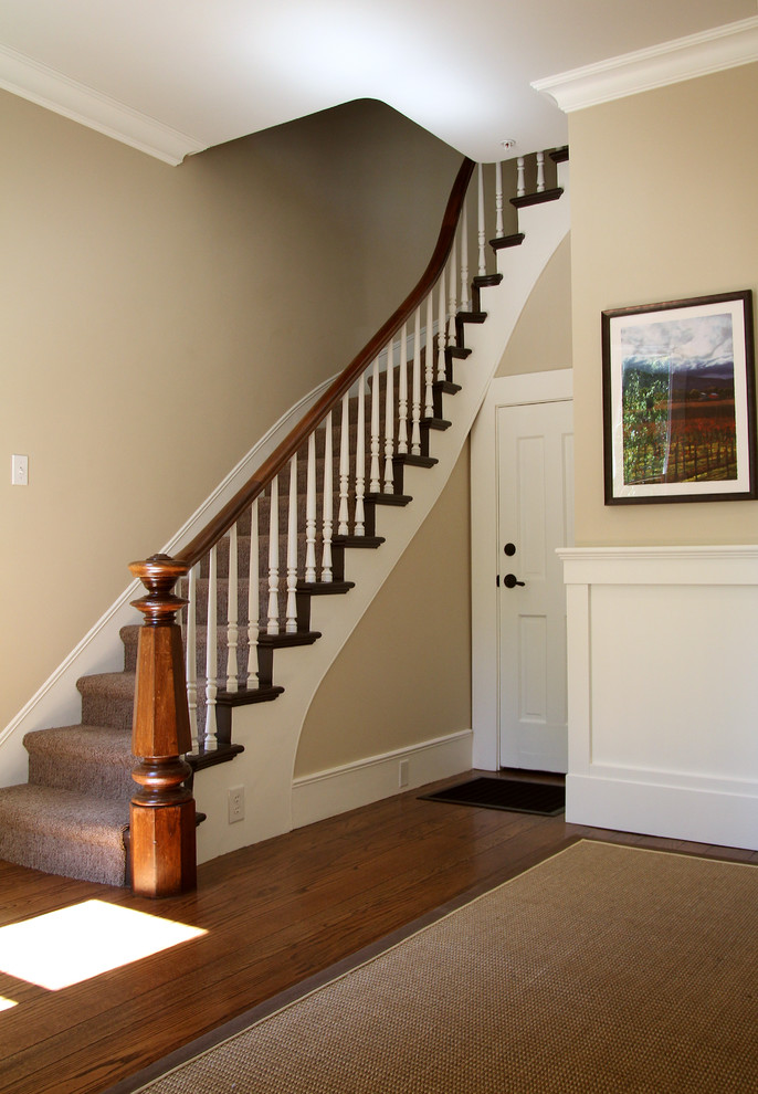 Photo of a mid-sized traditional carpeted curved staircase in San Francisco with carpet risers.