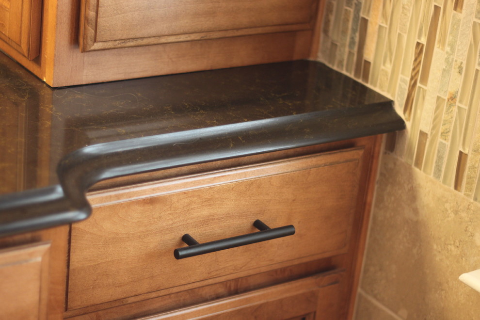 Mid-sized transitional master multicolored tile and ceramic tile bathroom photo in Charlotte with raised-panel cabinets, medium tone wood cabinets and quartzite countertops