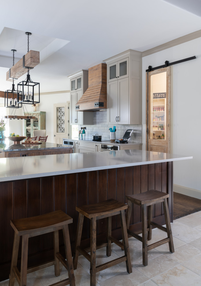 Inspiration for a large transitional dark wood floor, brown floor and exposed beam eat-in kitchen remodel with shaker cabinets, distressed cabinets, quartzite countertops, gray backsplash, ceramic backsplash, stainless steel appliances and an island