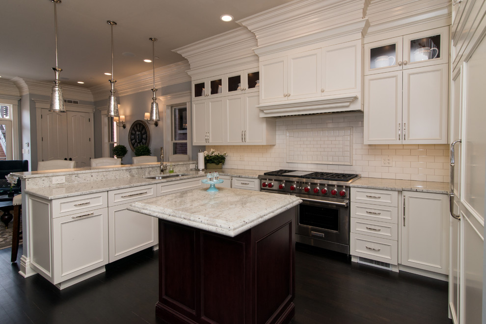 Design ideas for a mid-sized traditional u-shaped eat-in kitchen in Chicago with an undermount sink, shaker cabinets, white cabinets, marble benchtops, white splashback, subway tile splashback, stainless steel appliances, dark hardwood floors and with island.