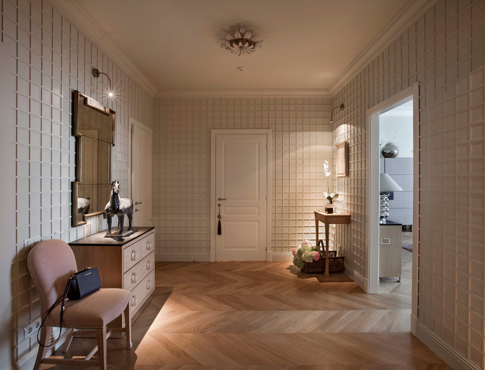 Inspiration for a traditional foyer in Moscow with white walls and light hardwood floors.