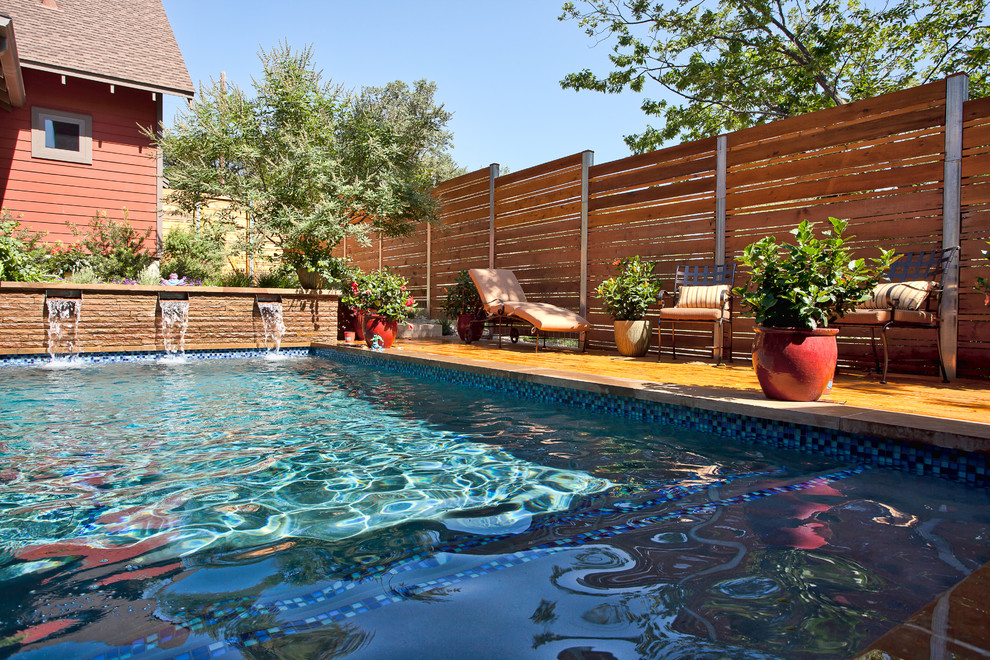 Mid-sized country backyard rectangular lap pool in Austin with concrete pavers.