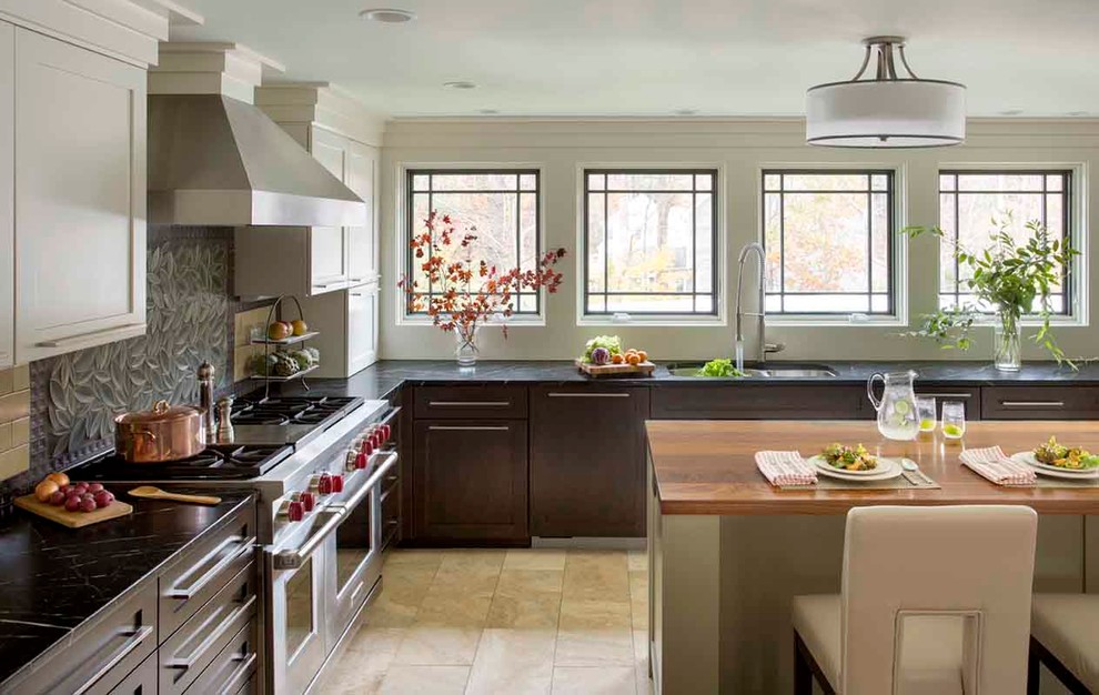 Inspiration for a traditional l-shaped kitchen in Boston with an undermount sink, shaker cabinets, dark wood cabinets, stainless steel appliances and with island.
