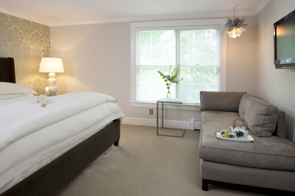 This is an example of a contemporary bedroom in Boston with beige walls and carpet.