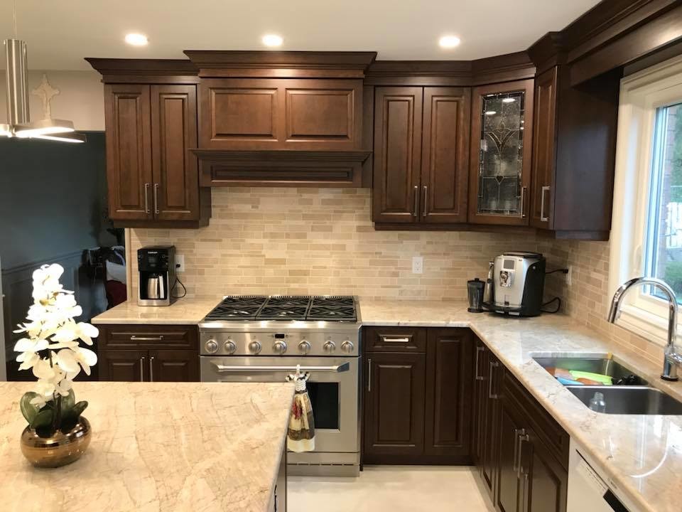 Inspiration for a transitional u-shaped marble floor and beige floor eat-in kitchen remodel with an undermount sink, raised-panel cabinets, beige cabinets, quartzite countertops, beige backsplash, marble backsplash, stainless steel appliances and an island