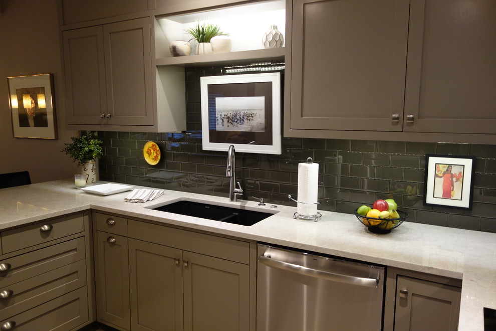 Home design - small transitional u-shaped ceramic tile home design idea with an undermount sink, shaker cabinets, gray cabinets, quartz countertops, gray backsplash, glass tile backsplash, stainless steel appliances and a peninsula