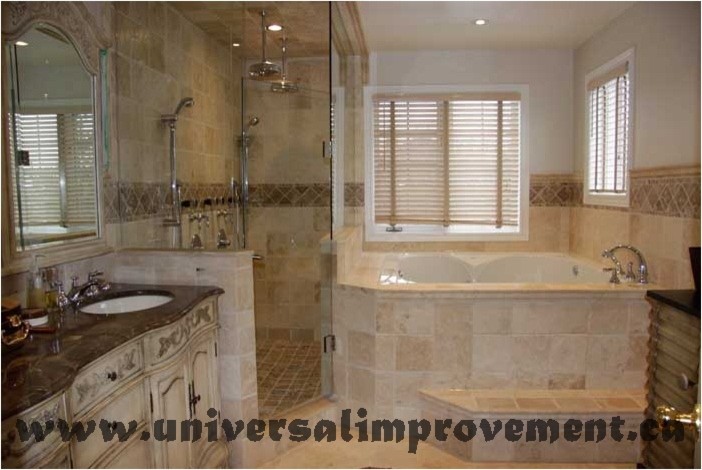 Photo of a large traditional master bathroom in Toronto with furniture-like cabinets, beige cabinets, a hot tub, an open shower, a one-piece toilet, beige tile, travertine, beige walls, travertine floors, an undermount sink, marble benchtops, beige floor, a hinged shower door and brown benchtops.