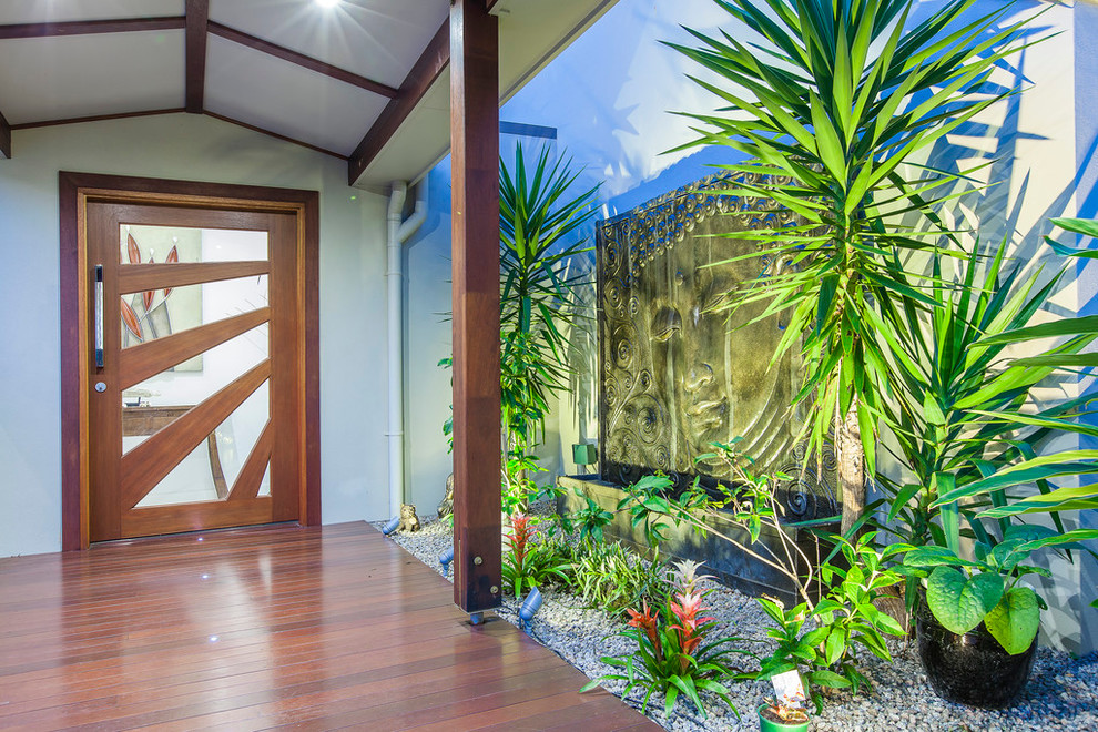 Design ideas for an asian front door in Sunshine Coast with a single front door and a glass front door.