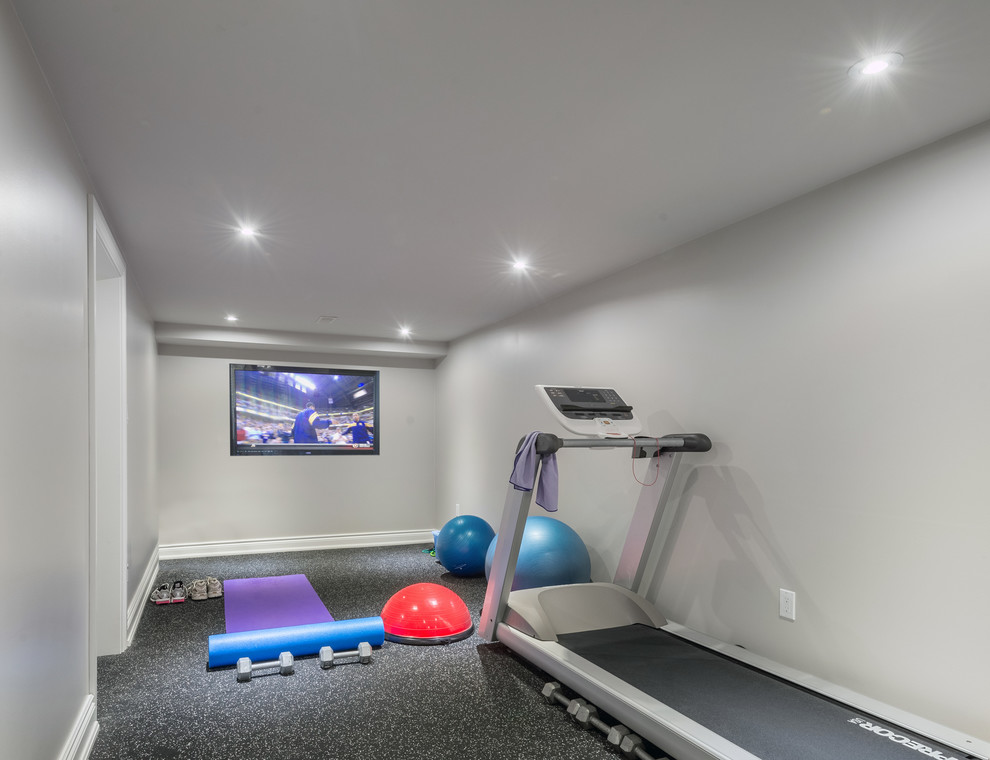 Small transitional multipurpose gym in Toronto with grey walls, vinyl floors and grey floor.