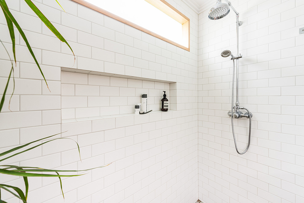 Mid-sized transitional 3/4 bathroom in Melbourne with open cabinets, medium wood cabinets, an open shower, a one-piece toilet, white tile, porcelain tile, white walls, porcelain floors, a wall-mount sink, brown floor and an open shower.