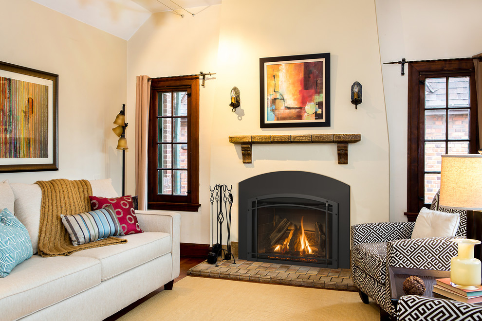 Photo of a mid-sized traditional formal enclosed living room in Boston with white walls, dark hardwood floors, a standard fireplace, a stone fireplace surround and no tv.