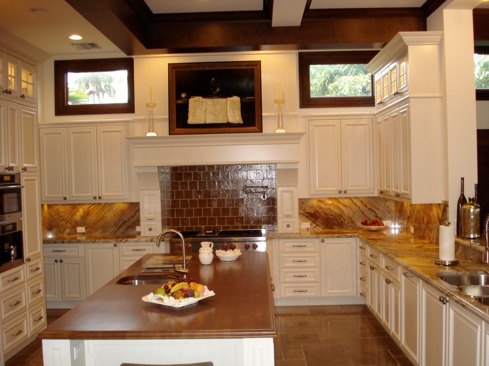 Example of a large transitional u-shaped limestone floor open concept kitchen design in Miami with an undermount sink, raised-panel cabinets, white cabinets, onyx countertops, multicolored backsplash, paneled appliances and an island