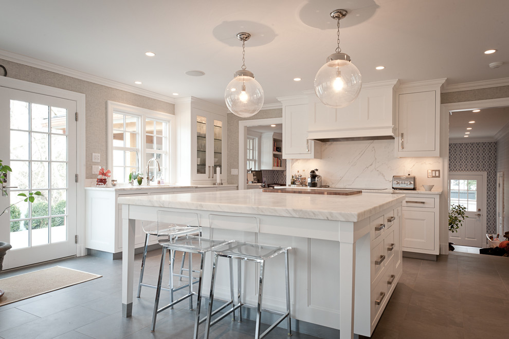 Inspiration for a transitional kitchen in New York with white cabinets, white splashback and with island.