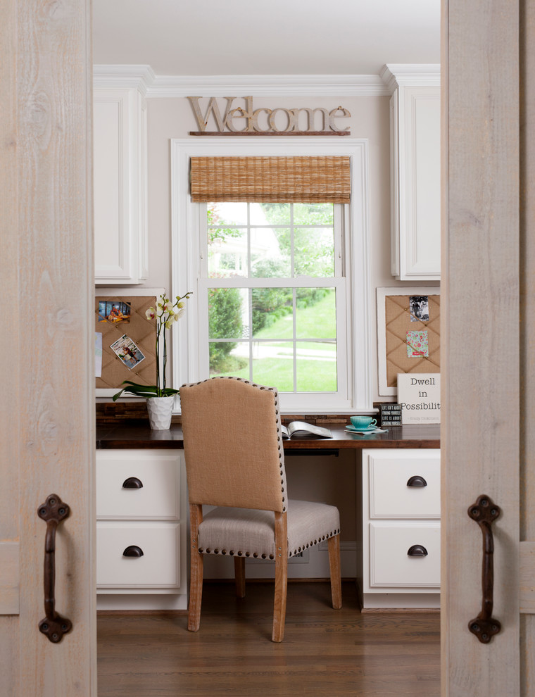 Design ideas for a traditional home office in DC Metro with beige walls, medium hardwood floors and a built-in desk.