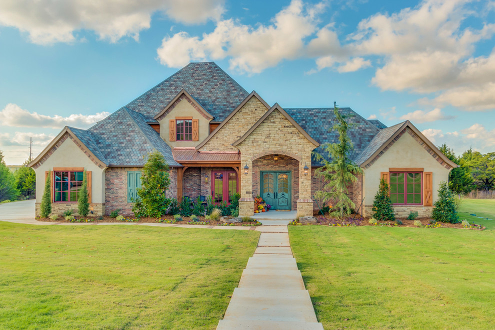 Photo of a large country two-storey brick exterior in Oklahoma City with a hip roof.