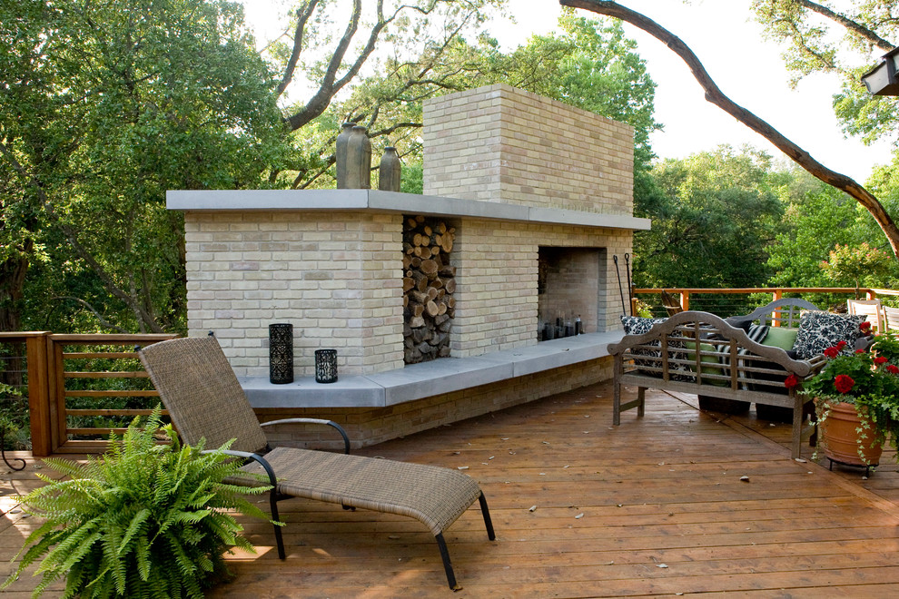Large midcentury backyard patio in Austin with a fire feature, decking and no cover.