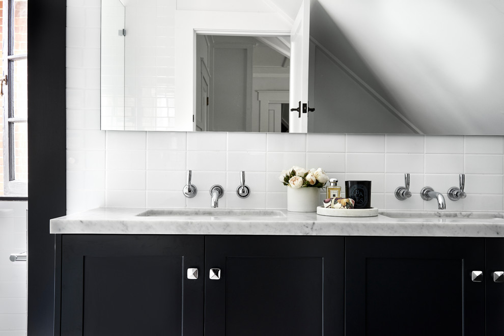 Mid-sized transitional kids bathroom in Sydney with shaker cabinets, black cabinets, a corner shower, a one-piece toilet, white tile, porcelain tile, white walls, marble floors, an undermount sink, marble benchtops and a hinged shower door.