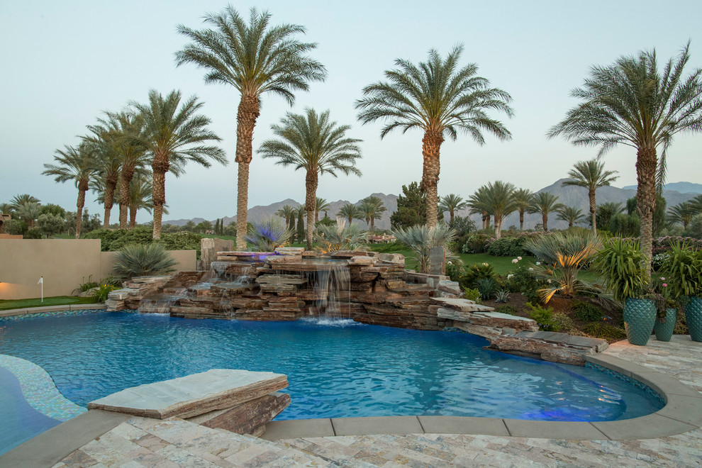 Mid-sized transitional backyard concrete paver and round natural pool fountain photo