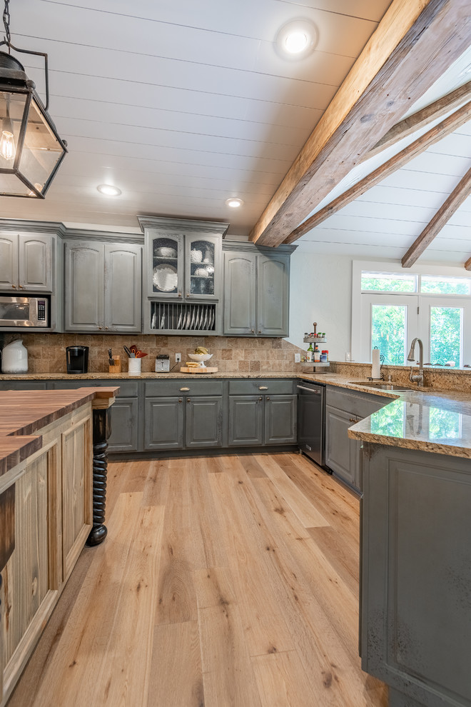 Design ideas for a country l-shaped kitchen in Other with an undermount sink, shaker cabinets, grey cabinets, granite benchtops, travertine splashback, stainless steel appliances, light hardwood floors, multiple islands and brown benchtop.