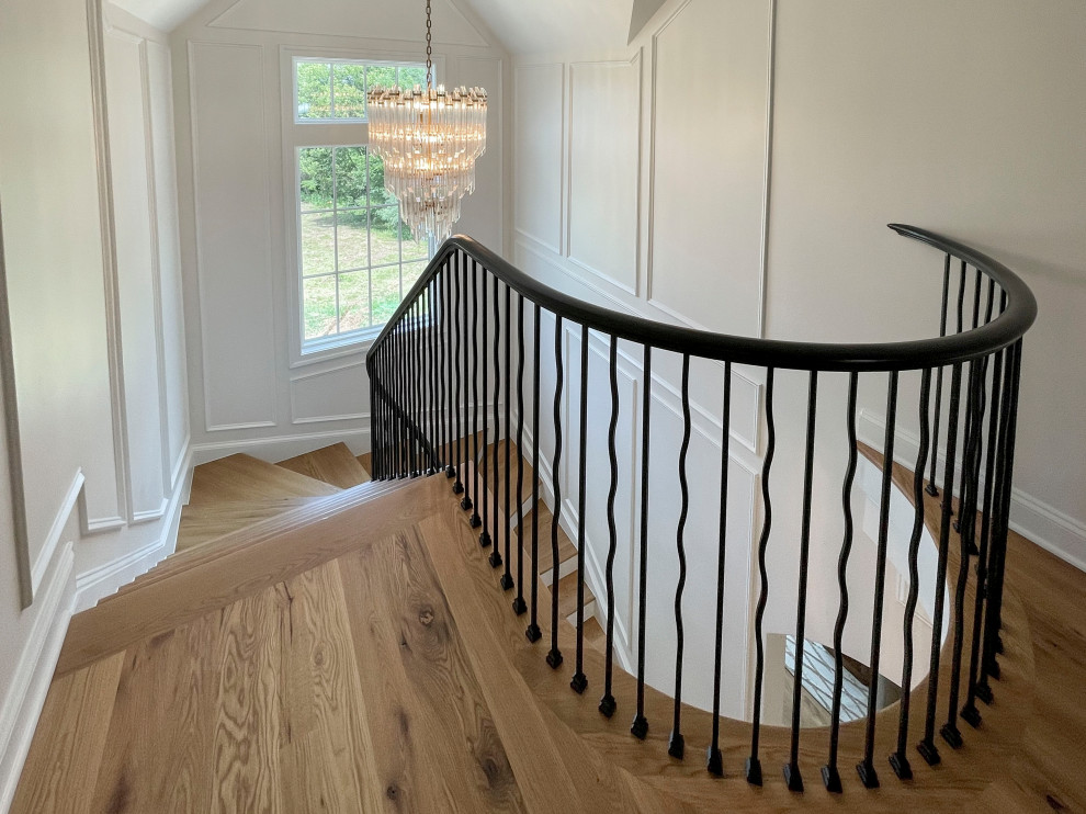 Design ideas for a large classic wood floating mixed railing staircase in DC Metro with painted wood risers and wainscoting.