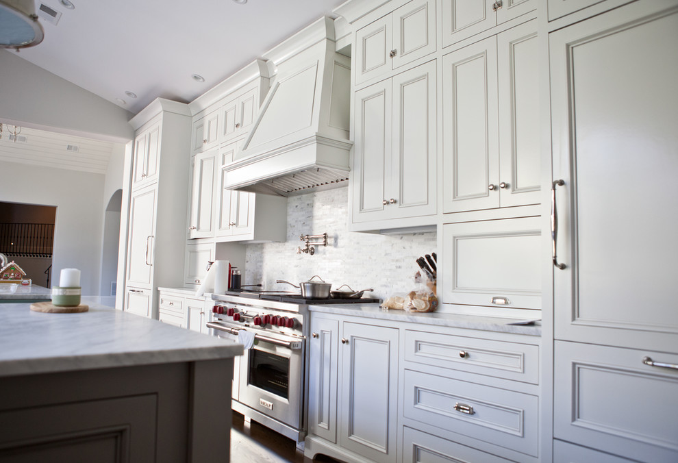 This is an example of a large transitional u-shaped separate kitchen in Atlanta with beaded inset cabinets, white cabinets, marble benchtops, grey splashback, matchstick tile splashback, stainless steel appliances and with island.