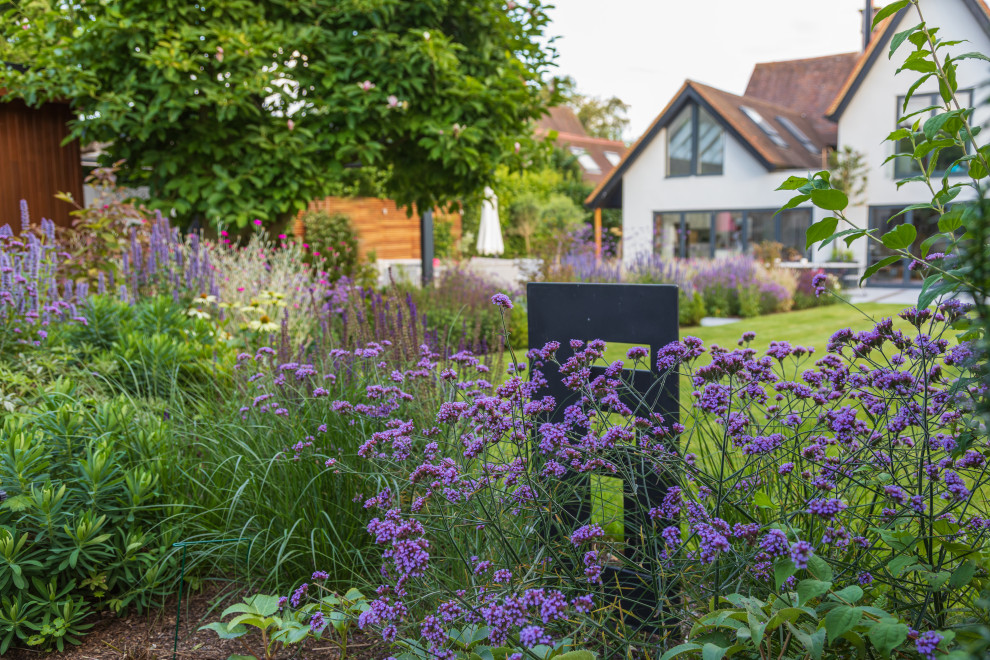Photo of a medium sized contemporary back formal full sun garden for summer in Buckinghamshire with a flowerbed.
