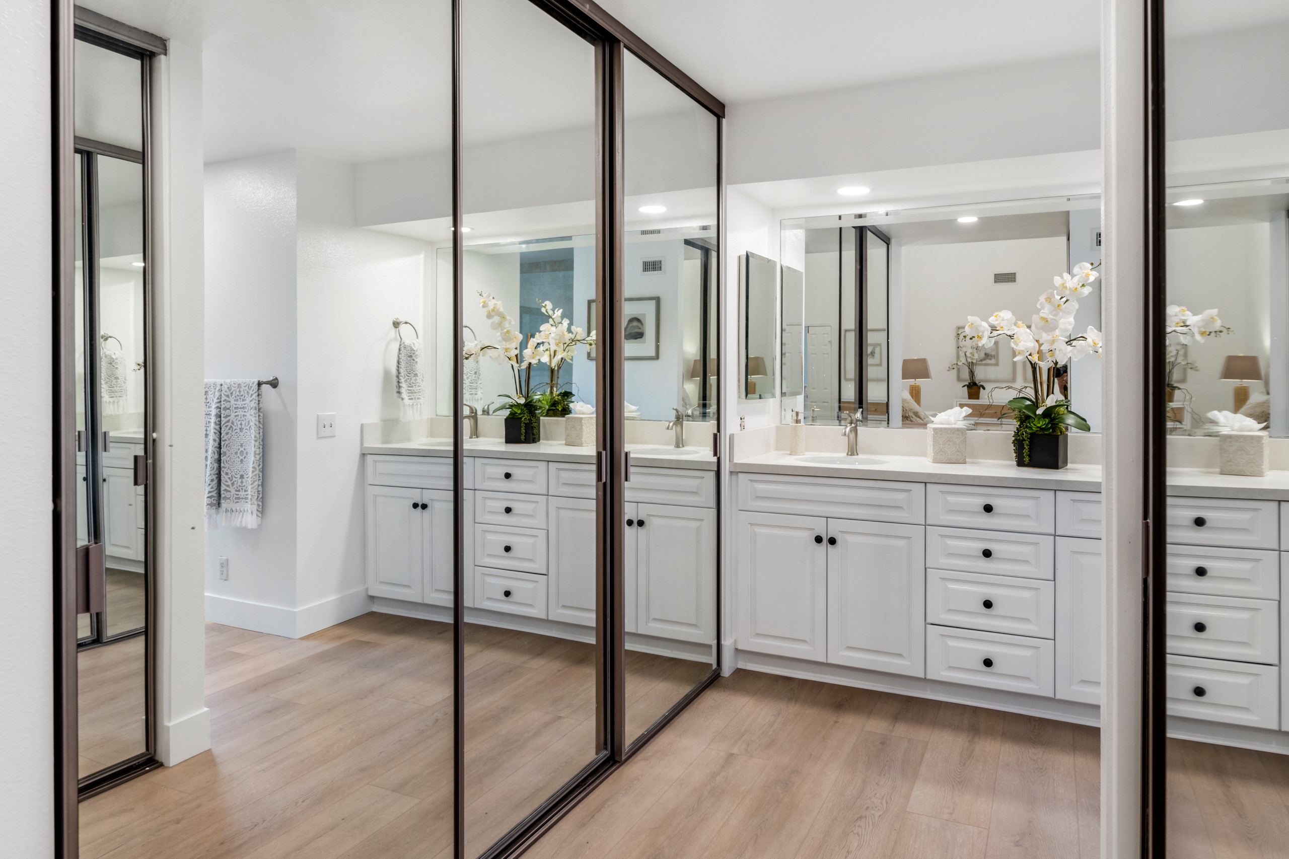 Bathroom - large modern master vinyl floor, brown floor and double-sink bathroom idea in Orange County with white cabinets, quartzite countertops, brown countertops, a built-in vanity and raised-panel