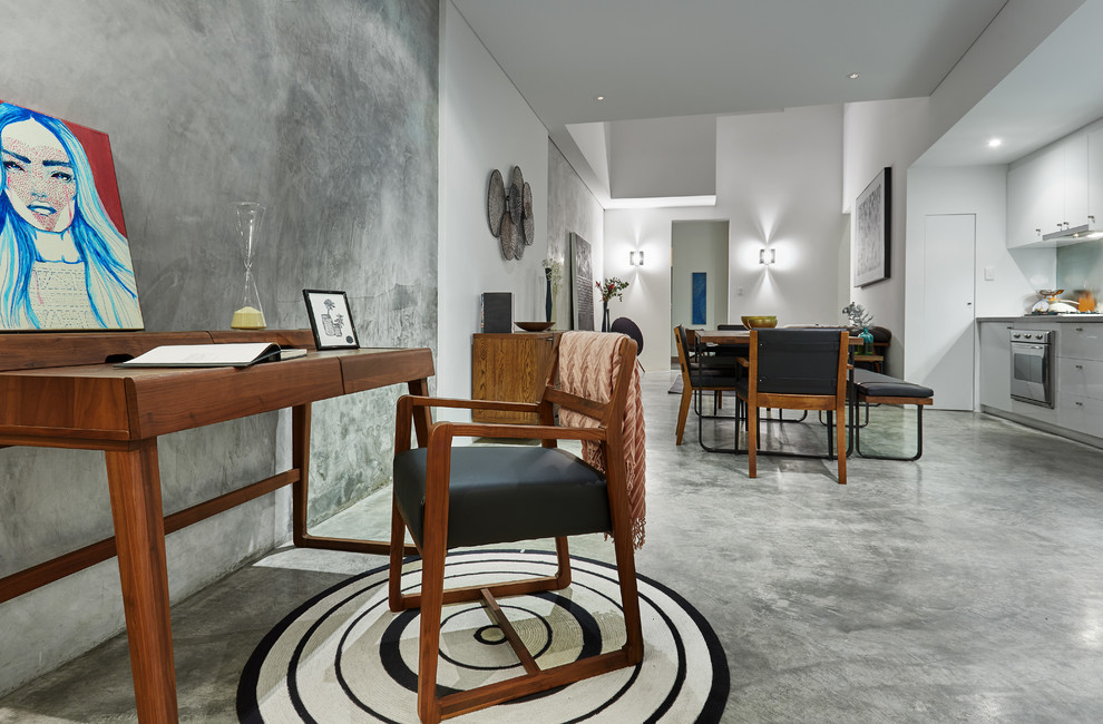 Photo of a small industrial study room in Perth with grey walls, concrete floors, no fireplace, a freestanding desk and grey floor.