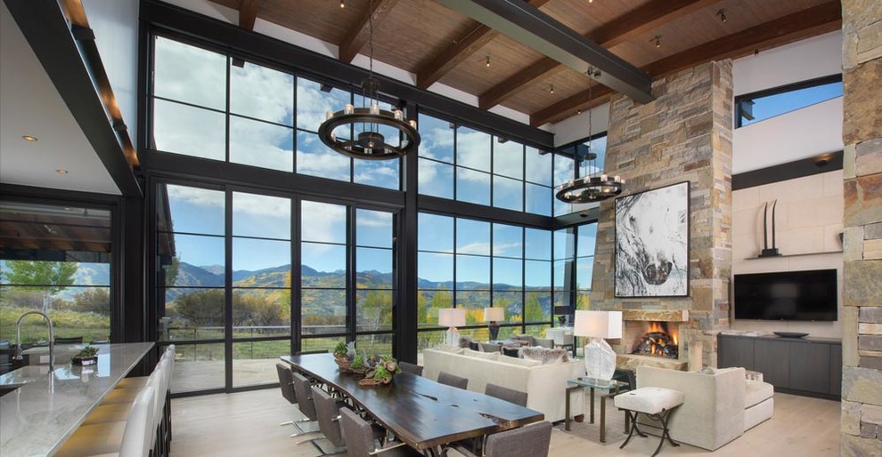 Living room - huge contemporary open concept light wood floor living room idea in Denver with a standard fireplace, a stone fireplace and a wall-mounted tv