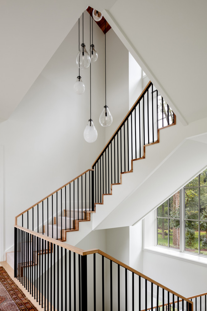 Inspiration for a huge country wooden l-shaped metal railing staircase remodel in DC Metro with wooden risers