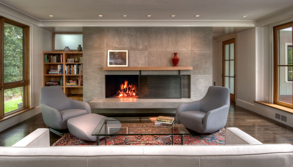 This is an example of an asian living room in Boston with grey walls and a standard fireplace.
