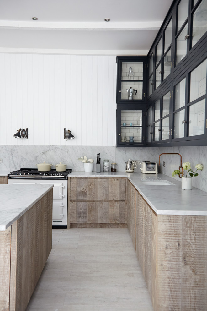 Inspiration for a scandi kitchen in London with a submerged sink, glass-front cabinets, white appliances, an island and grey splashback.