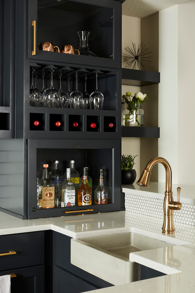 Design ideas for a large transitional u-shaped seated home bar in Minneapolis with an undermount sink, recessed-panel cabinets, black cabinets, quartz benchtops, white splashback, subway tile splashback, vinyl floors and grey floor.